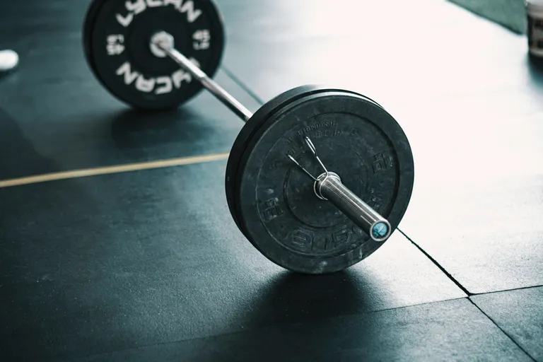 Barbell on gym floor.