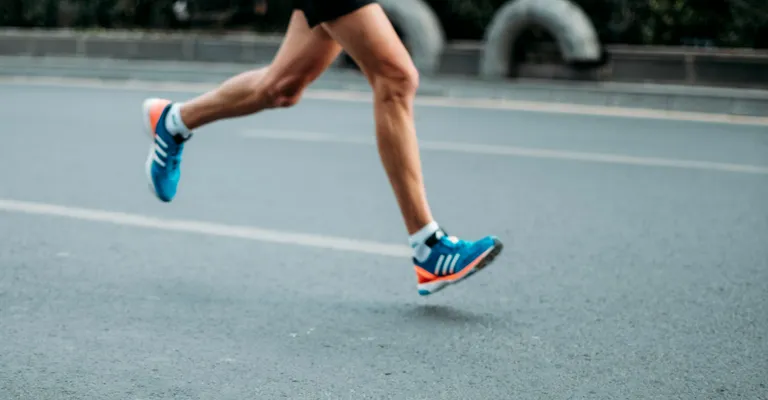 Man running on road.